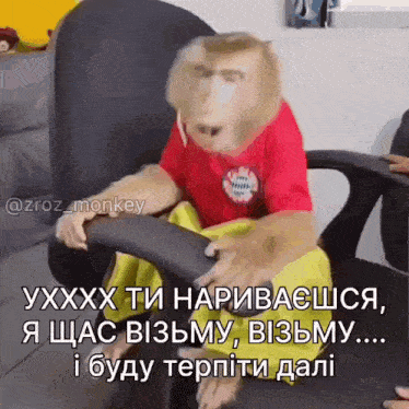 a monkey wearing a red shirt and yellow shorts is sitting in an office chair .