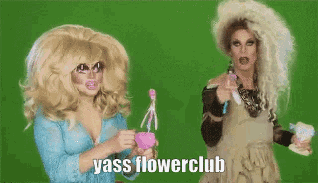 two drag queens standing next to each other with yass flowerclub written on the screen