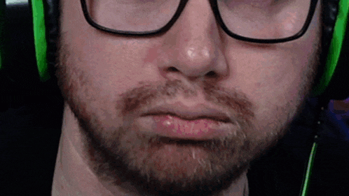 a man with glasses and a beard is wearing headphones
