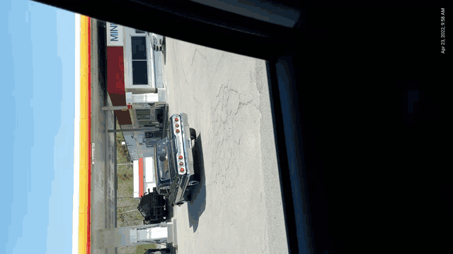 a car is driving past a gas station that says min