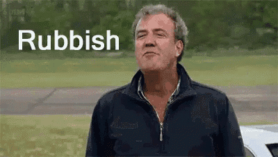 a man is standing in a field with a car in the background and the word rubbish is on his face .