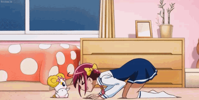 a girl in a blue skirt is kneeling down in front of a hamster in a bedroom