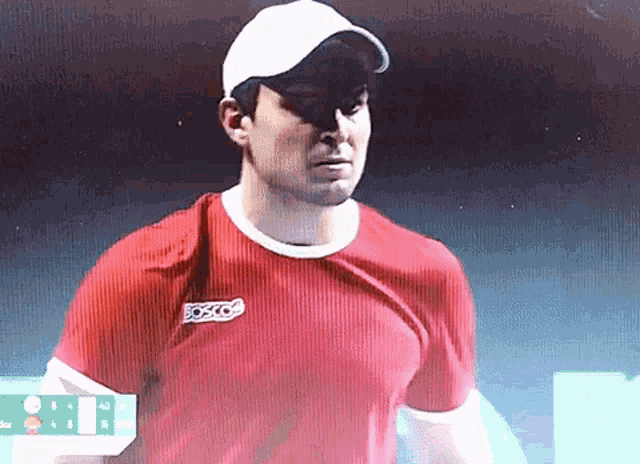 a man wearing a red shirt with the word bosco on the chest