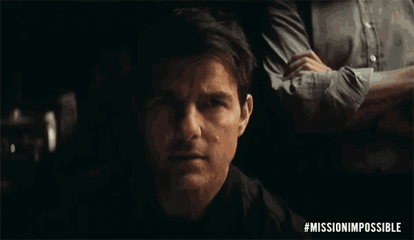 a close up of a man 's face with the words mission impossible written on the bottom
