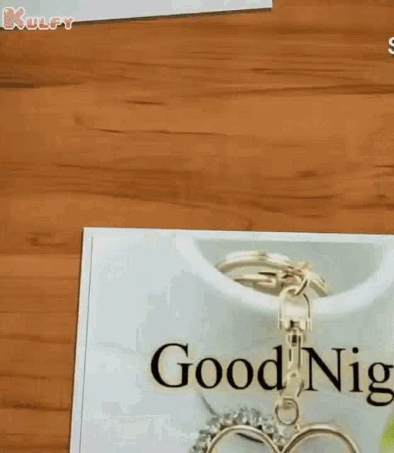a good night card with a heart shaped keychain and the letter s on it