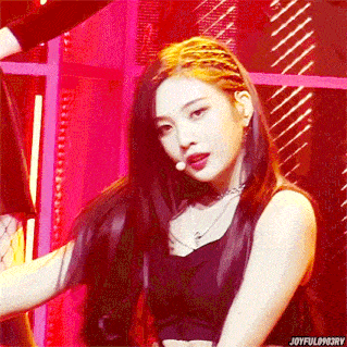 a woman with long hair is wearing a braided hairstyle and a choker necklace .