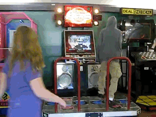 a girl is playing an arcade game with a sign that says deal & no cash