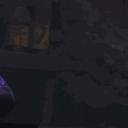 a blurry picture of a person in a car with a purple light behind them