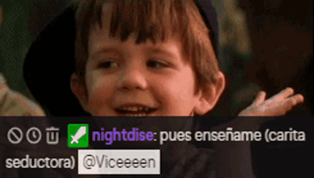 a boy in a hat is smiling in front of a screen that says seductora