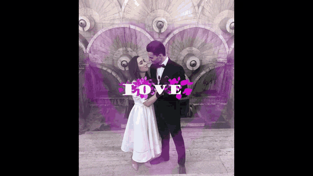 a bride and groom are kissing in front of a wall with the word love written on it