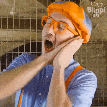 a man in a blue shirt and orange suspenders is yawning