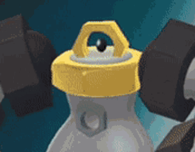 a close up of a cartoon character with a yellow cap on it