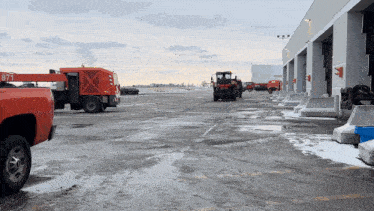 a red truck with the number 877 on the back is parked in a parking lot