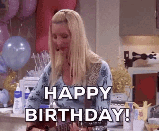 a woman is holding a guitar and singing happy birthday .