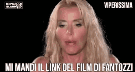 a close up of a woman 's face with the words `` mi mandi il link del film di fantozzi '' written on the bottom .