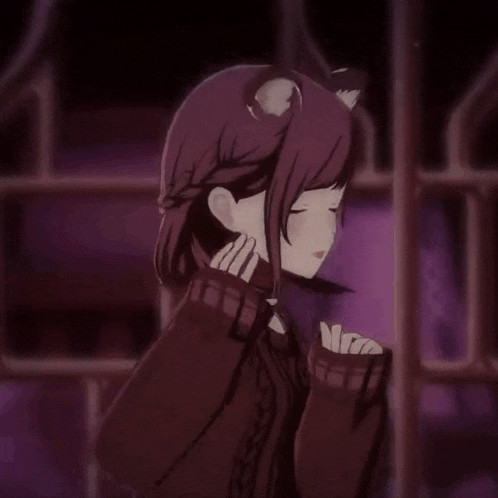 a girl with a cat ear on her head in a dark room