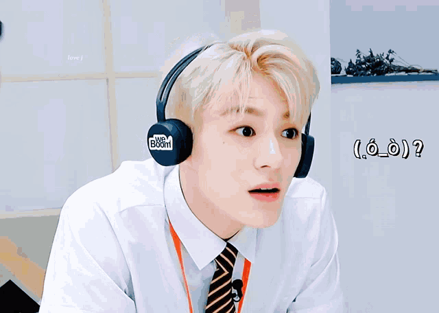 a man wearing headphones that say we boom on it