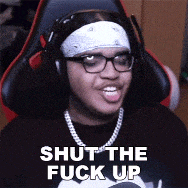 a man wearing headphones and a bandana says " shut the fuck up "