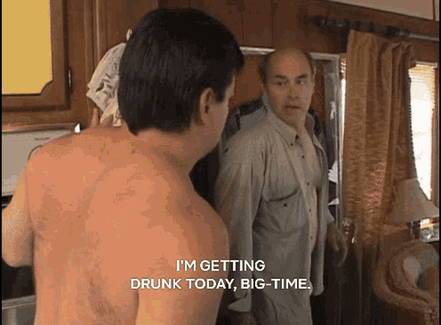a shirtless man in a kitchen says i 'm getting drunk today big-time