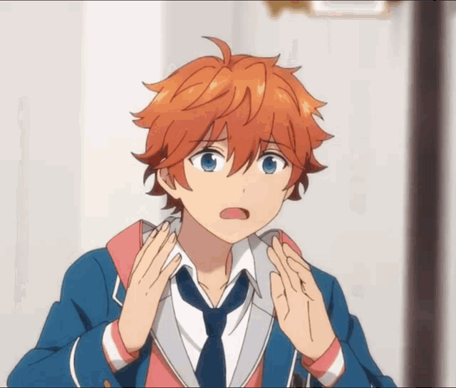 a boy with orange hair and blue eyes is making a surprised face