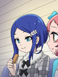 a girl with blue hair is holding a piece of chocolate