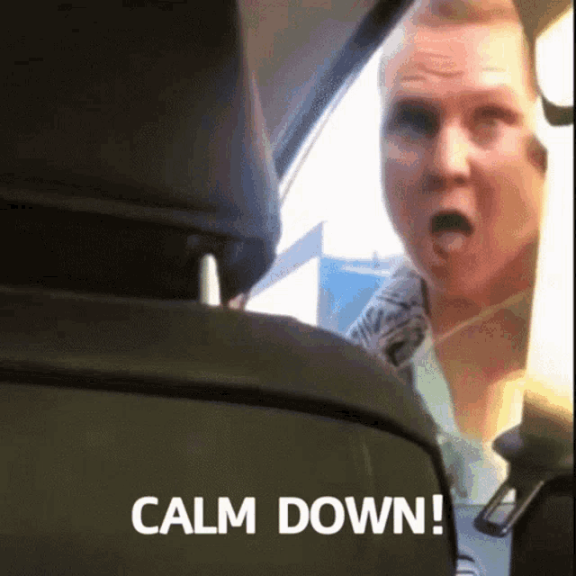 a man sitting in the back seat of a car with the words calm down written on the bottom