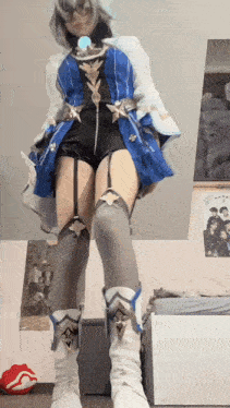 a woman in a cosplay costume is standing in a room .