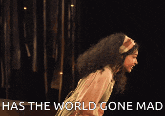 a woman in a green dress screams with the words has the world gone mad below her