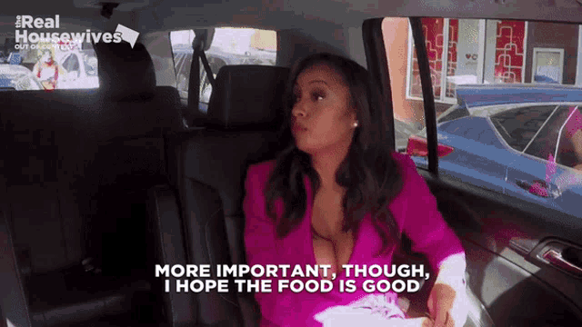a woman in a pink jacket is sitting in the back seat of a car with the words more important though i hope the food is good