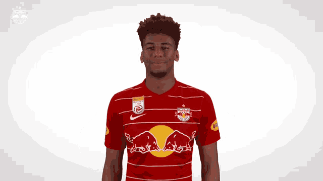 a man wearing a red and white red bull jersey