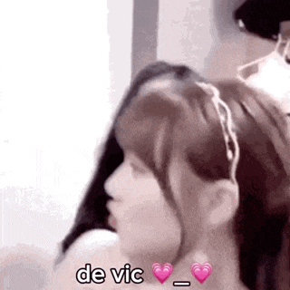 a close up of a woman 's face with a headband on her head and the words `` de vic '' .