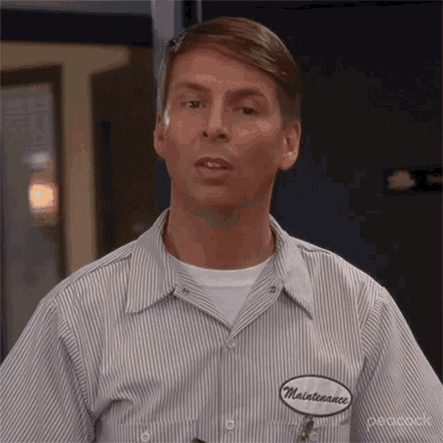 a man wearing a striped shirt with a patch that says maintenance