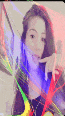 a woman 's face is surrounded by a rainbow of colored lines