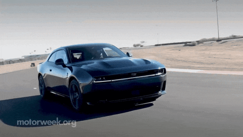 a black car is driving down a road with the words motorweek.org behind it
