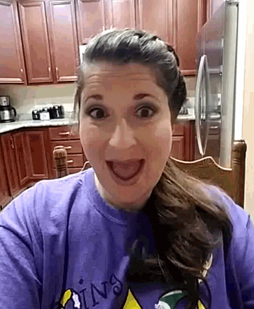 a woman is wearing a purple shirt that says coins