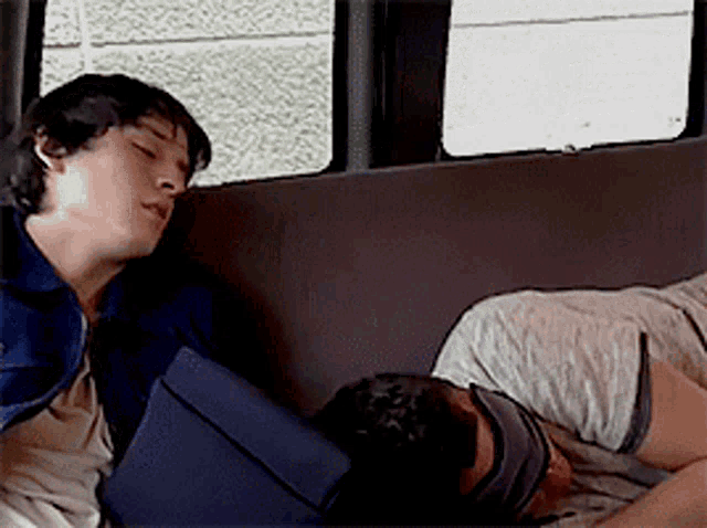 a man is sleeping in the back seat of a van
