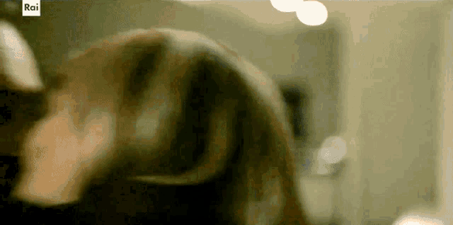 a close up of a person 's face with the rai logo in the corner