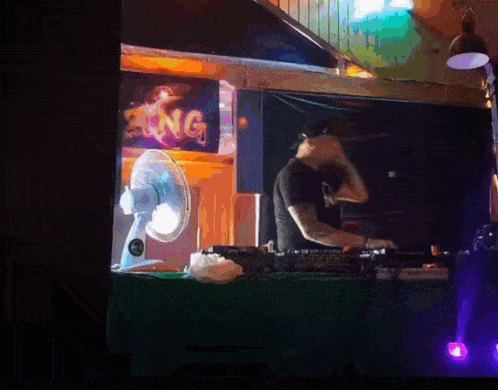 a man is playing music in front of a sign that says zing