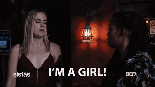 a woman says i 'm a girl in front of a bet logo