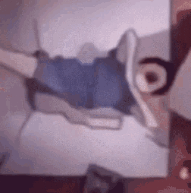 a blurry picture of a person laying on a bed with their arms outstretched .
