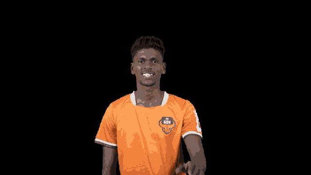 a man wearing an orange shirt that says ' fc leipzig ' on it