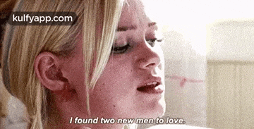 a close up of a woman 's face with the words `` i found two new men to love '' .