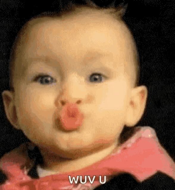 a baby is making a funny face with his mouth open .