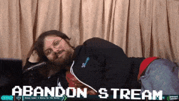 a man laying on the floor with the words abandon stream behind him
