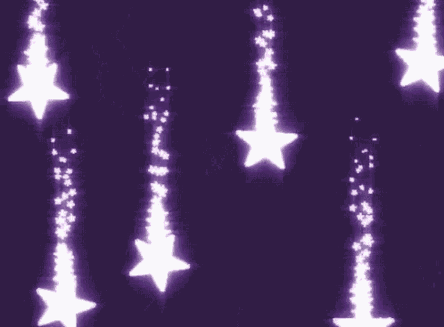 a purple background with a lot of stars falling from the sky .