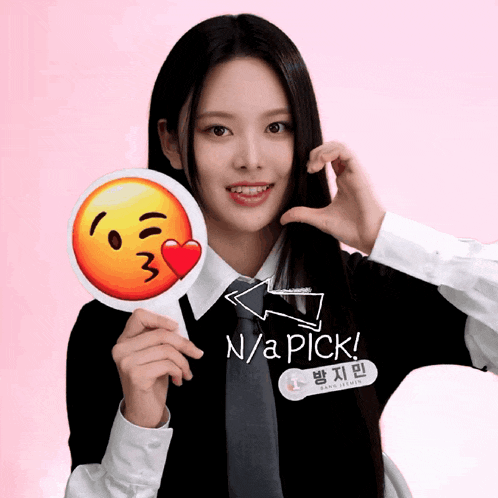 a girl is holding a sign that says n / a pick on it