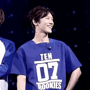 a young man wearing a blue shirt that says ten rookies