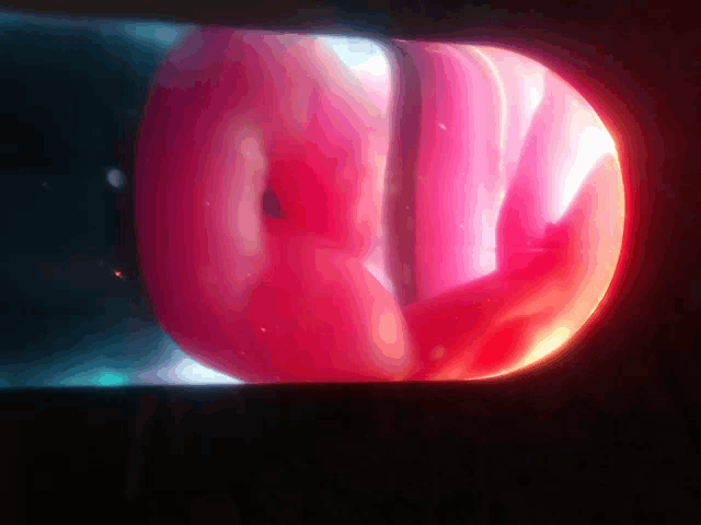 a close up of a red object with a glowing center