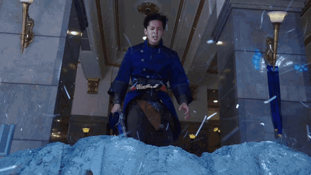 a man in a blue costume is standing on a pile of snow