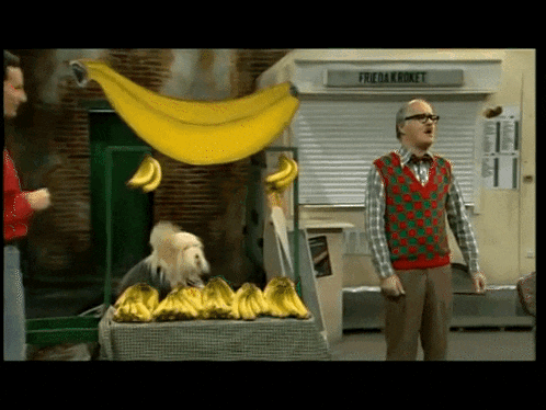 a man stands in front of a banana stand with a sign that says frida kroket